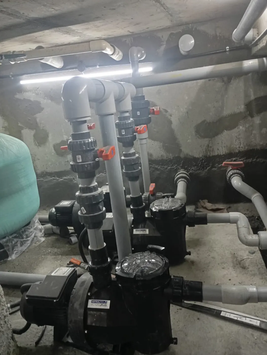 Swimming pool plant room with filtration pumps, valves and sand filter
