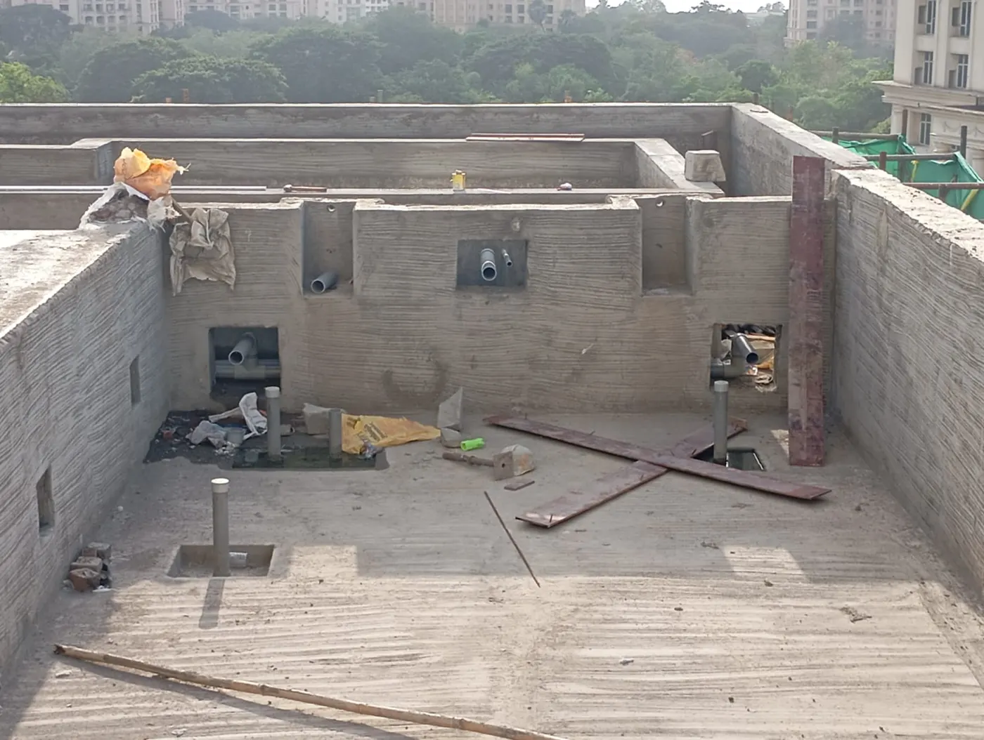 RCC swimming pool shell under construction with inlet and outlet pipe sleeves